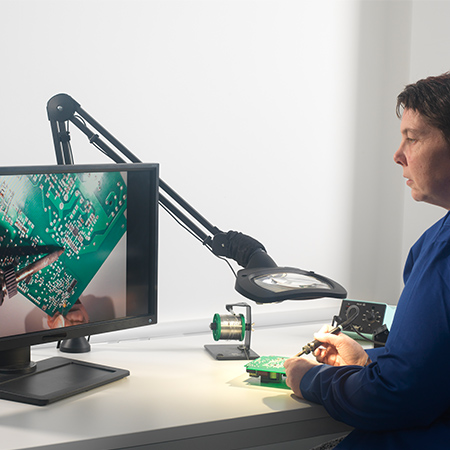 BenchKam-on-Wave-ESD-soldering-application-450x450px man using BenchKam camera on bench magnifier looking at screen