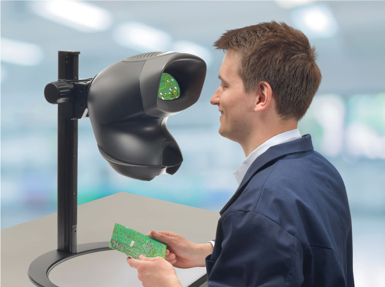 OPTA-magnifier-on-crescent-stand-man-inspecting-pcb-768x572px Technician using Mantis Elite stereo microscope for dental application